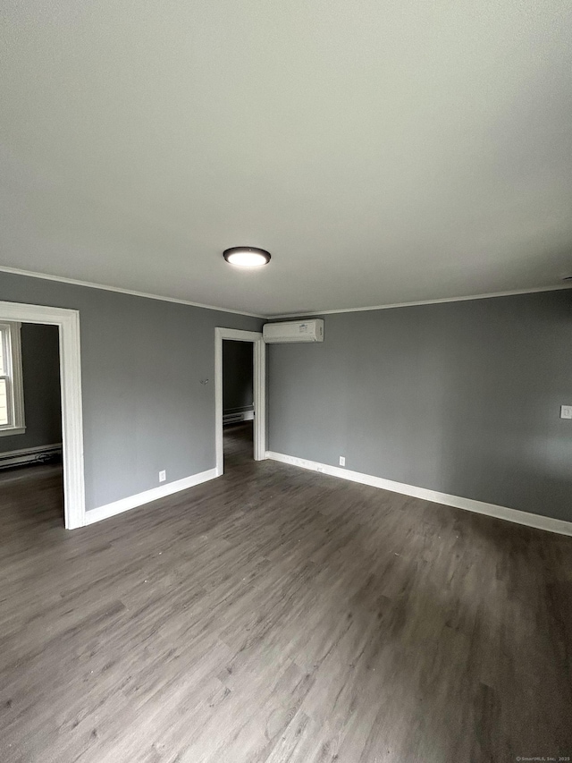51 Division St, Norwich, CT 06360 - spare room featuring wood finished floors, a wall unit AC, and a baseboard heating unit