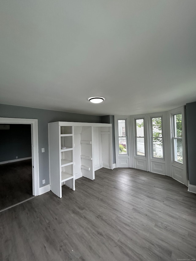 51 Division St, Norwich, CT 06360 - unfurnished bedroom with dark wood-style flooring and baseboards