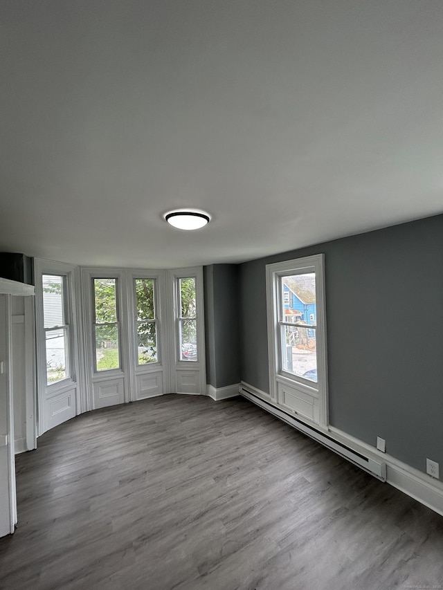 51 Division St, Norwich, CT 06360 - spare room with wood finished floors and a baseboard heating unit