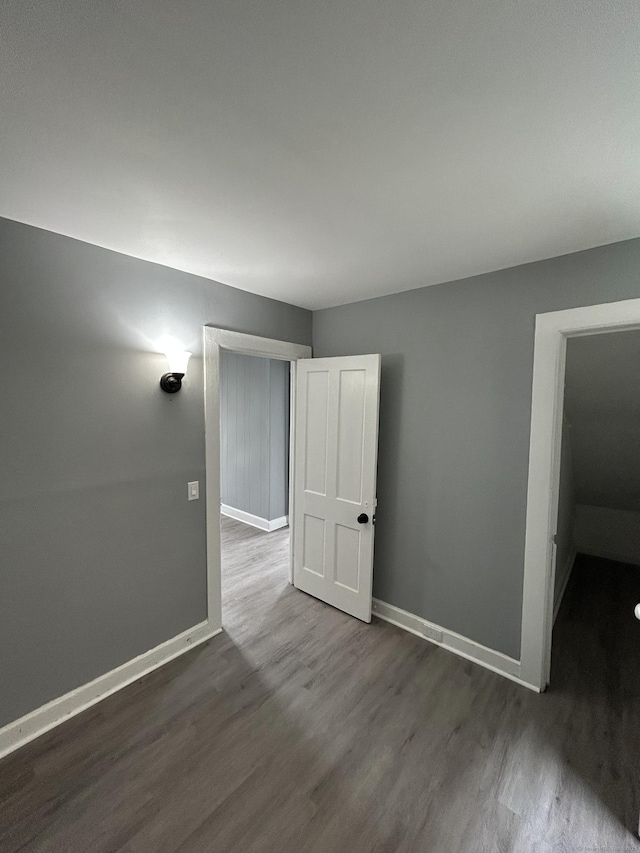 51 Division St, Norwich, CT 06360 - empty room featuring dark wood-type flooring and baseboards