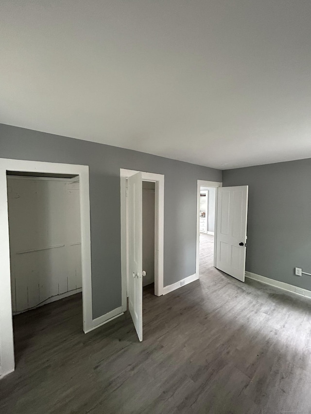 51 Division St, Norwich, CT 06360 - unfurnished bedroom featuring dark wood-style flooring and baseboards