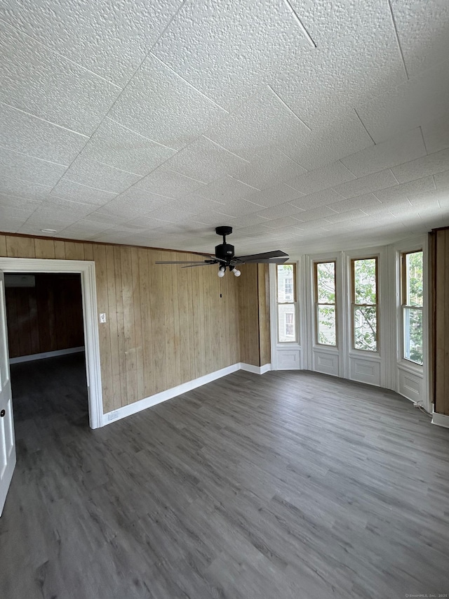 51 Division St, Norwich, CT 06360 - unfurnished living room with ceiling fan, dark wood finished floors, and wood walls