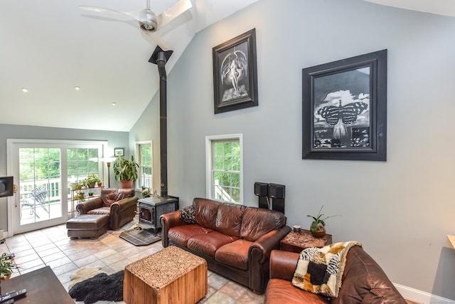 10 Heritage Way, Barkhamsted, CT 06063 - living room featuring a wood stove, plenty of natural light, ceiling fan, and high vaulted ceiling