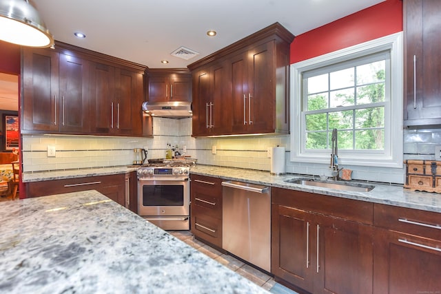 10 Heritage Way, Barkhamsted, CT 06063 - kitchen with appliances with stainless steel finishes, under cabinet range hood, tasteful backsplash, light stone countertops, and recessed lighting