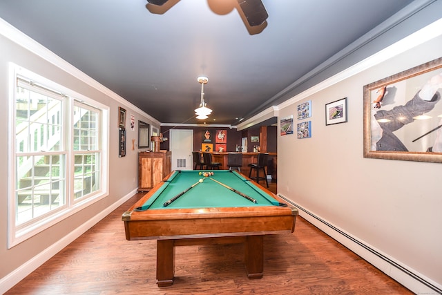 10 Heritage Way, Barkhamsted, CT 06063 - game room featuring baseboard heating, ornamental molding, bar, a ceiling fan, and wood finished floors