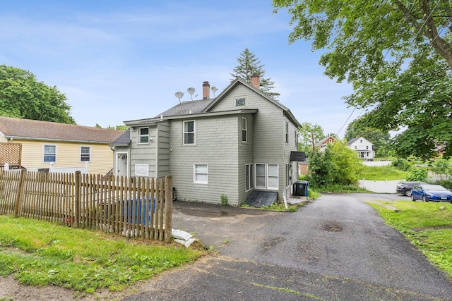 24 Maple St, Torrington, CT 06790 - view of home's exterior with a chimney and driveway