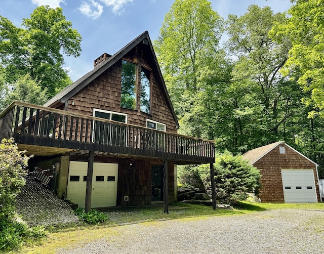 115B Torrington Ave, Canton, CT 06019 - view of front of house featuring a deck, a garage, driveway, and an outbuilding