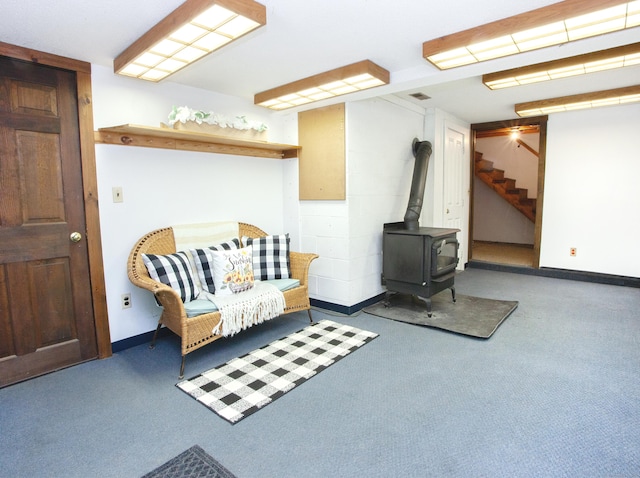 115B Torrington Ave, Canton, CT 06019 - living area with carpet flooring, a wood stove, stairs, and baseboards