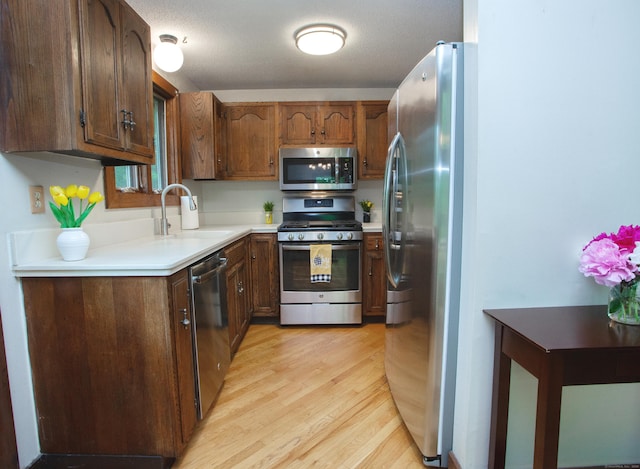 115B Torrington Ave, Canton, CT 06019 - kitchen featuring stainless steel appliances, a sink, light wood-type flooring, and light countertops