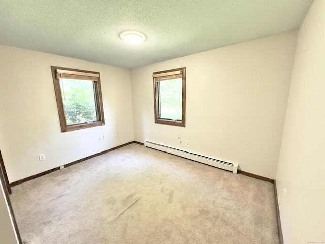 115B Torrington Ave, Canton, CT 06019 - empty room with a baseboard heating unit, healthy amount of natural light, carpet floors, baseboards, and a textured ceiling