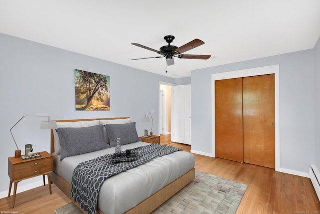 21 Enfield St, Windsor Locks, CT 06096 - bedroom featuring baseboard heating, baseboards, light wood-style floors, a closet, and a ceiling fan