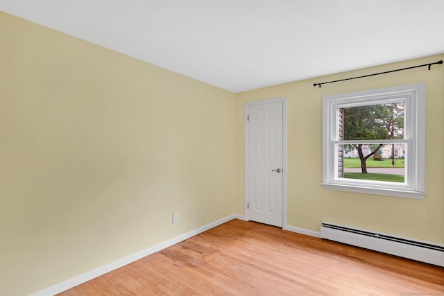 21 Enfield St, Windsor Locks, CT 06096 - empty room with baseboard heating, baseboards, and light wood-style flooring