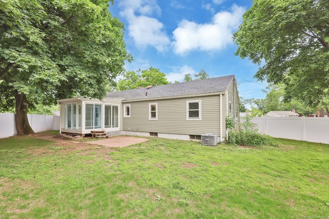 21 Enfield St, Windsor Locks, CT 06096 - back of property featuring a sunroom, cooling unit, a patio, and a shingled roof