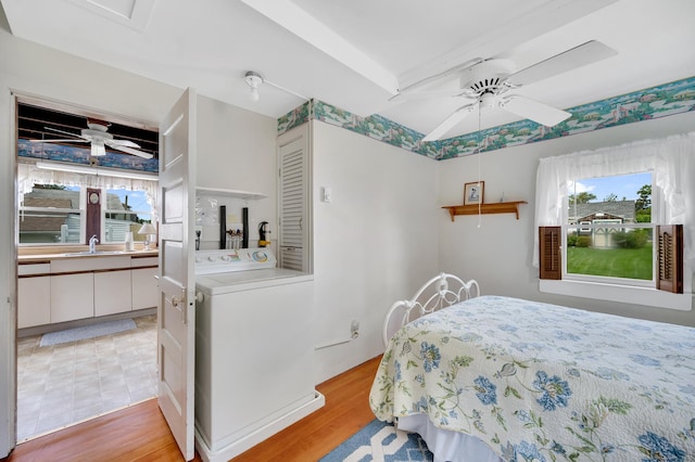 7 Meriden Ave, Westbrook, CT 06498 - bedroom with washer / clothes dryer, multiple windows, light wood-style floors, and a ceiling fan