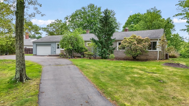 1704 Hill St, Suffield, CT 06078 - view of front of house with an attached garage, asphalt driveway, a front lawn, a chimney, and stone siding