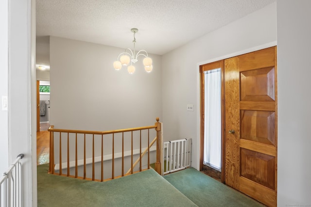 1704 Hill St, Suffield, CT 06078 - carpeted foyer entrance with a chandelier and a textured ceiling