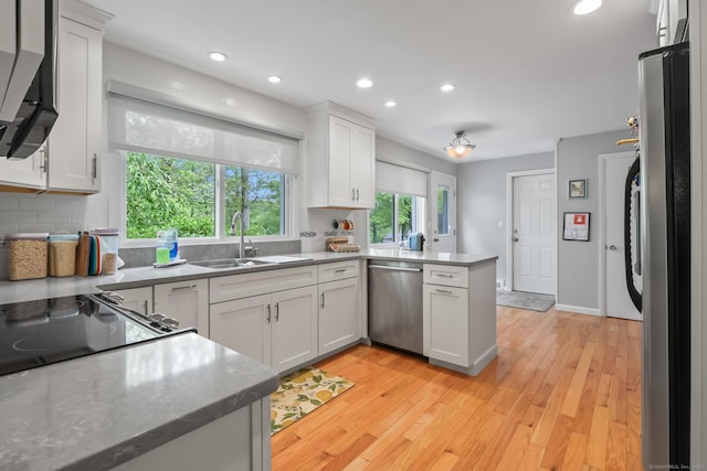 1704 Hill St, Suffield, CT 06078 - kitchen with appliances with stainless steel finishes, a peninsula, recessed lighting, white cabinets, and light wood-style floors