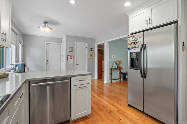 1704 Hill St, Suffield, CT 06078 - kitchen with stainless steel appliances, a peninsula, white cabinets, light wood-type flooring, and recessed lighting