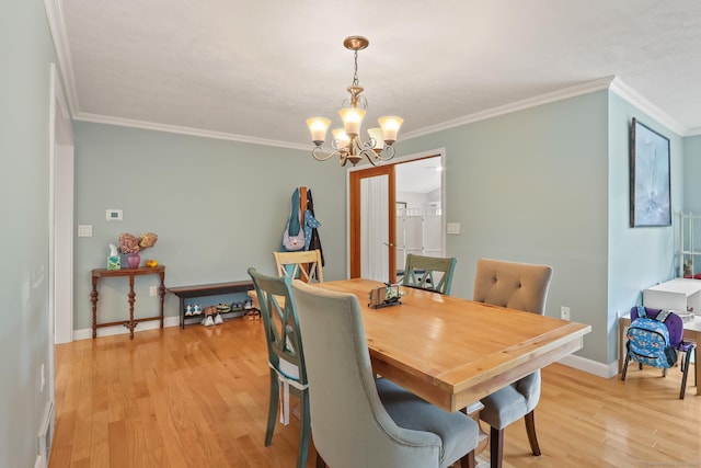 1704 Hill St, Suffield, CT 06078 - dining area featuring a chandelier, light wood finished floors, and ornamental molding