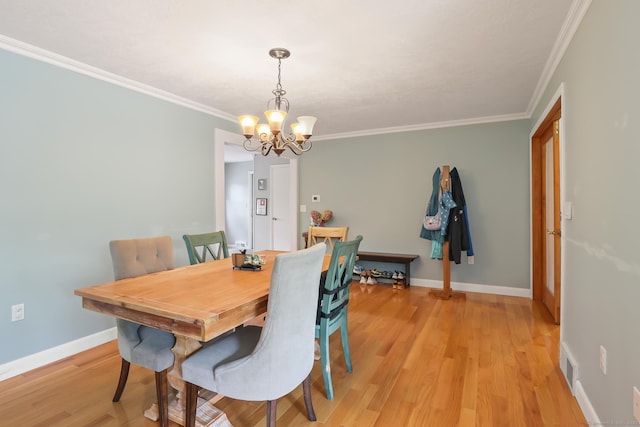1704 Hill St, Suffield, CT 06078 - dining area with a chandelier, light wood-style flooring, and crown molding