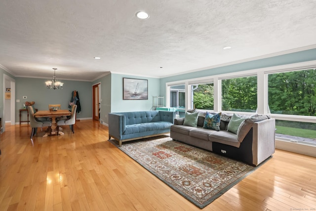 1704 Hill St, Suffield, CT 06078 - living area featuring a chandelier, ornamental molding, light wood-style flooring, a textured ceiling, and recessed lighting