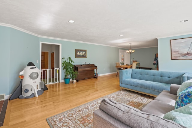 1704 Hill St, Suffield, CT 06078 - living room with a chandelier, wood finished floors, crown molding, and recessed lighting