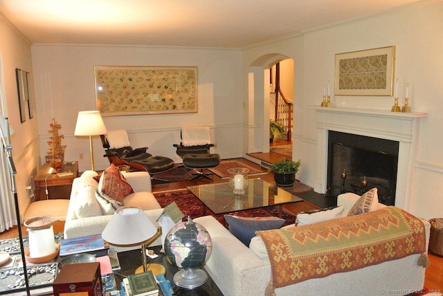 175 Tokeneke Dr, North Haven, CT 06473 - living area with arched walkways, ornamental molding, a fireplace, and wood finished floors