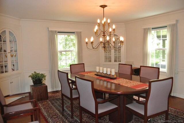 175 Tokeneke Dr, North Haven, CT 06473 - dining space featuring a chandelier, crown molding, and wood finished floors