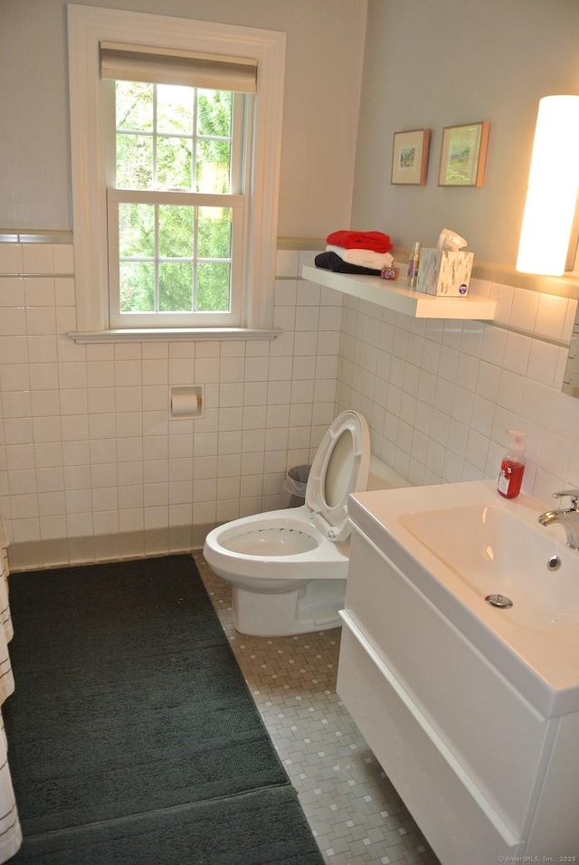175 Tokeneke Dr, North Haven, CT 06473 - bathroom with tile walls, tile patterned flooring, toilet, vanity, and wainscoting