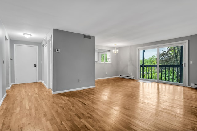 19 Harbour Vlg Unit B, Branford, CT 06405 - empty room featuring a baseboard heating unit, a chandelier, light wood-style floors, and baseboards