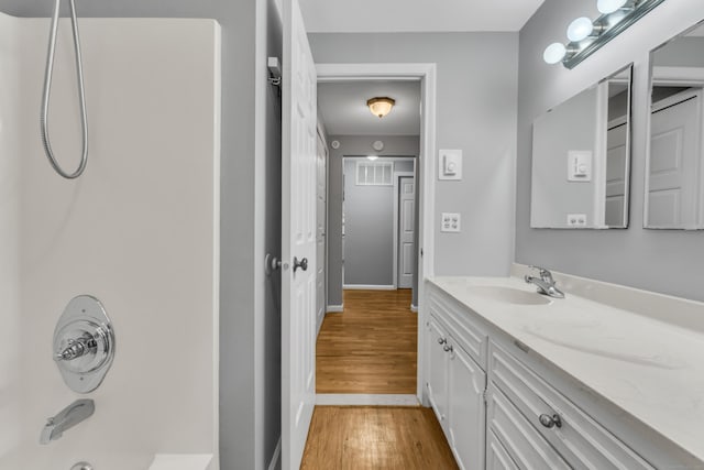 19 Harbour Vlg Unit B, Branford, CT 06405 - bathroom featuring vanity, wood finished floors, shower / washtub combination, and baseboards