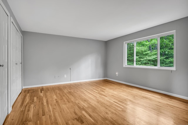 19 Harbour Vlg Unit B, Branford, CT 06405 - unfurnished bedroom featuring baseboards, light wood-type flooring, and a closet