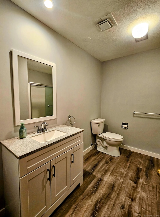 42 Village Rd Unit 42, Southington, CT 06489 - full bath with wood finished floors, toilet, vanity, baseboards, and a shower