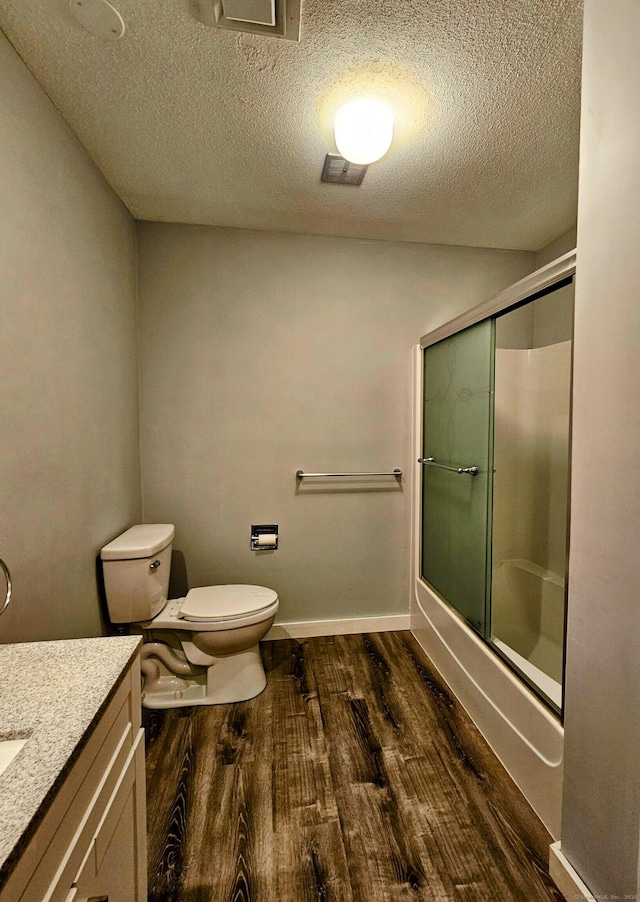 42 Village Rd Unit 42, Southington, CT 06489 - full bathroom with wood finished floors, vanity, toilet, a textured ceiling, and enclosed tub / shower combo