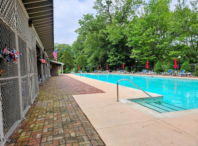 42 Village Rd Unit 42, Southington, CT 06489 - community pool featuring a patio area and view of wooded area