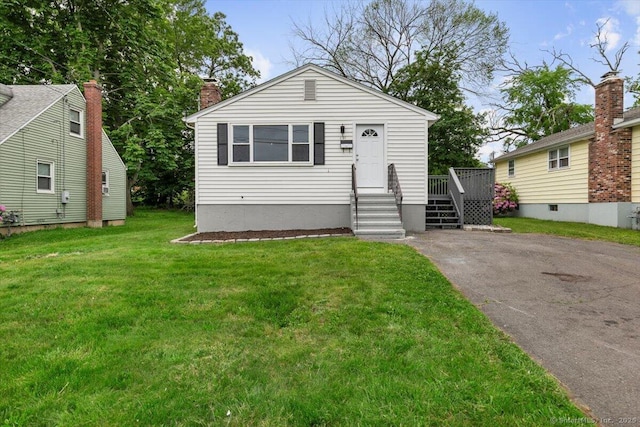 121 Lurton St, New Britain, CT 06053 - view of front of house with a front lawn, a chimney, and driveway