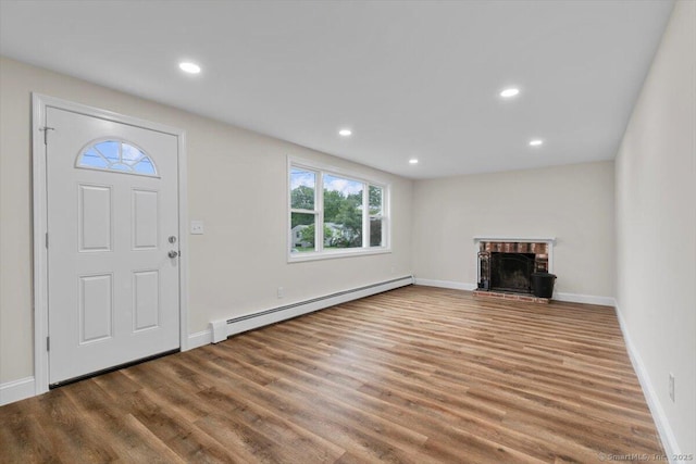 121 Lurton St, New Britain, CT 06053 - unfurnished living room with a baseboard heating unit, healthy amount of natural light, wood finished floors, baseboards, and recessed lighting