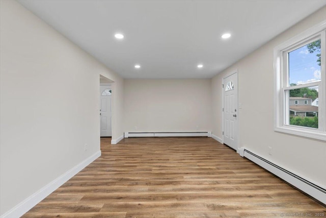 121 Lurton St, New Britain, CT 06053 - spare room featuring a baseboard heating unit, recessed lighting, wood finished floors, and baseboards