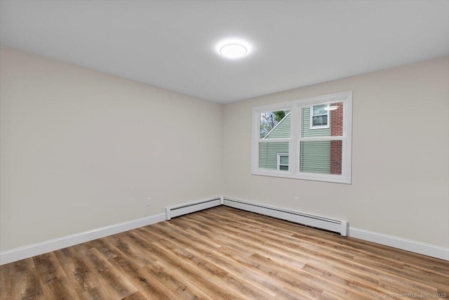121 Lurton St, New Britain, CT 06053 - unfurnished room with wood finished floors, baseboards, and a baseboard radiator