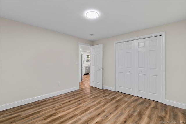 121 Lurton St, New Britain, CT 06053 - unfurnished bedroom featuring wood finished floors, baseboards, and a closet