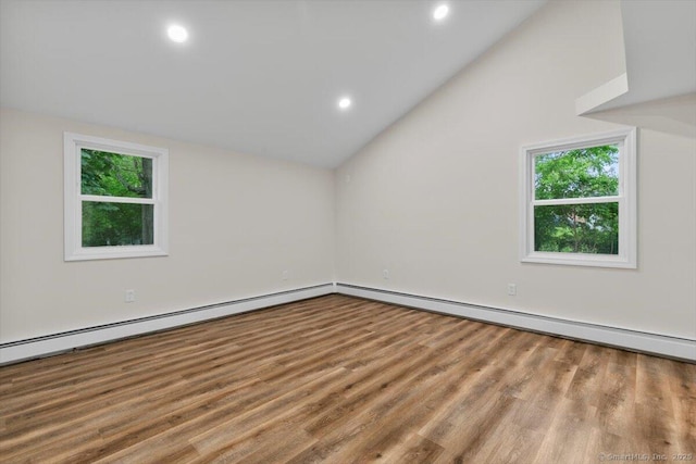 121 Lurton St, New Britain, CT 06053 - empty room with plenty of natural light, vaulted ceiling, wood finished floors, recessed lighting, and a baseboard radiator