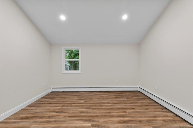 121 Lurton St, New Britain, CT 06053 - spare room featuring baseboard heating, wood finished floors, recessed lighting, vaulted ceiling, and baseboards
