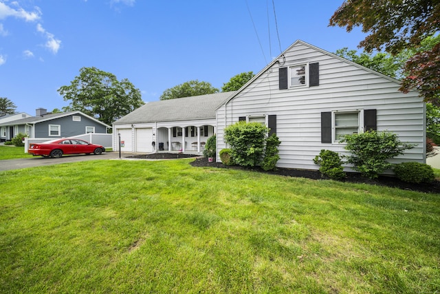 327 Steele St, New Britain, CT 06052 - view of front of house with a garage, driveway, and a front lawn
