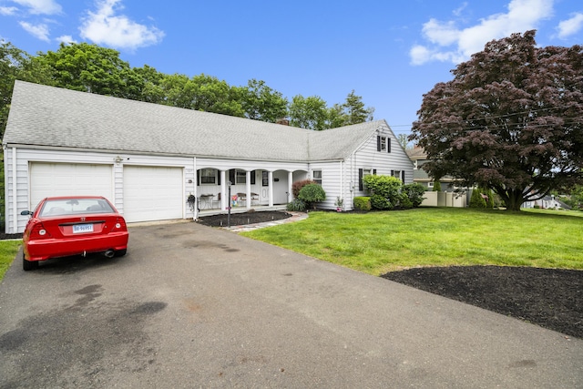 327 Steele St, New Britain, CT 06052 - view of front of home with covered porch, a garage, a front lawn, driveway, and a chimney
