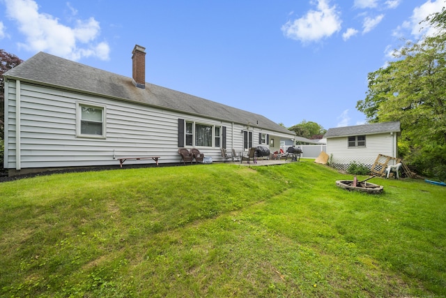 327 Steele St, New Britain, CT 06052 - back of house with a fire pit, a chimney, a lawn, and a patio
