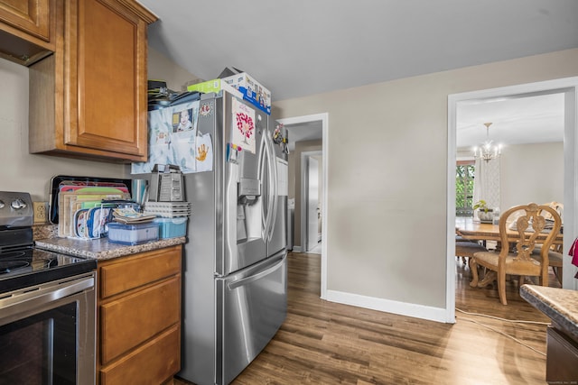 327 Steele St, New Britain, CT 06052 - kitchen with stainless steel appliances, dark wood-type flooring, a chandelier, brown cabinets, and baseboards