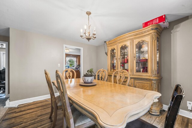 327 Steele St, New Britain, CT 06052 - dining room with a chandelier, baseboards, and dark wood-type flooring