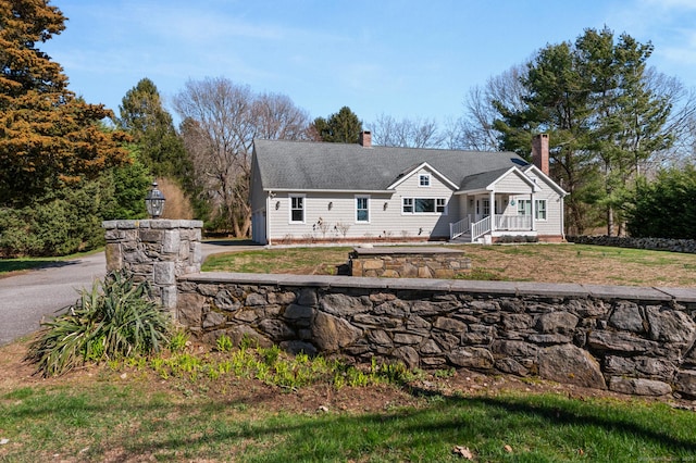 27 Quarry Rd, Stonington, CT 06355 - view of front facade featuring a porch, a chimney, and a front yard