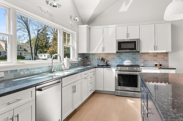27 Quarry Rd, Stonington, CT 06355 - kitchen featuring stainless steel appliances, white cabinets, tasteful backsplash, and vaulted ceiling
