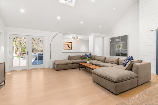 27 Quarry Rd, Stonington, CT 06355 - living room with high vaulted ceiling, light wood-style flooring, french doors, recessed lighting, and a skylight